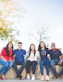 group of people sitting on bench near trees duting daytime