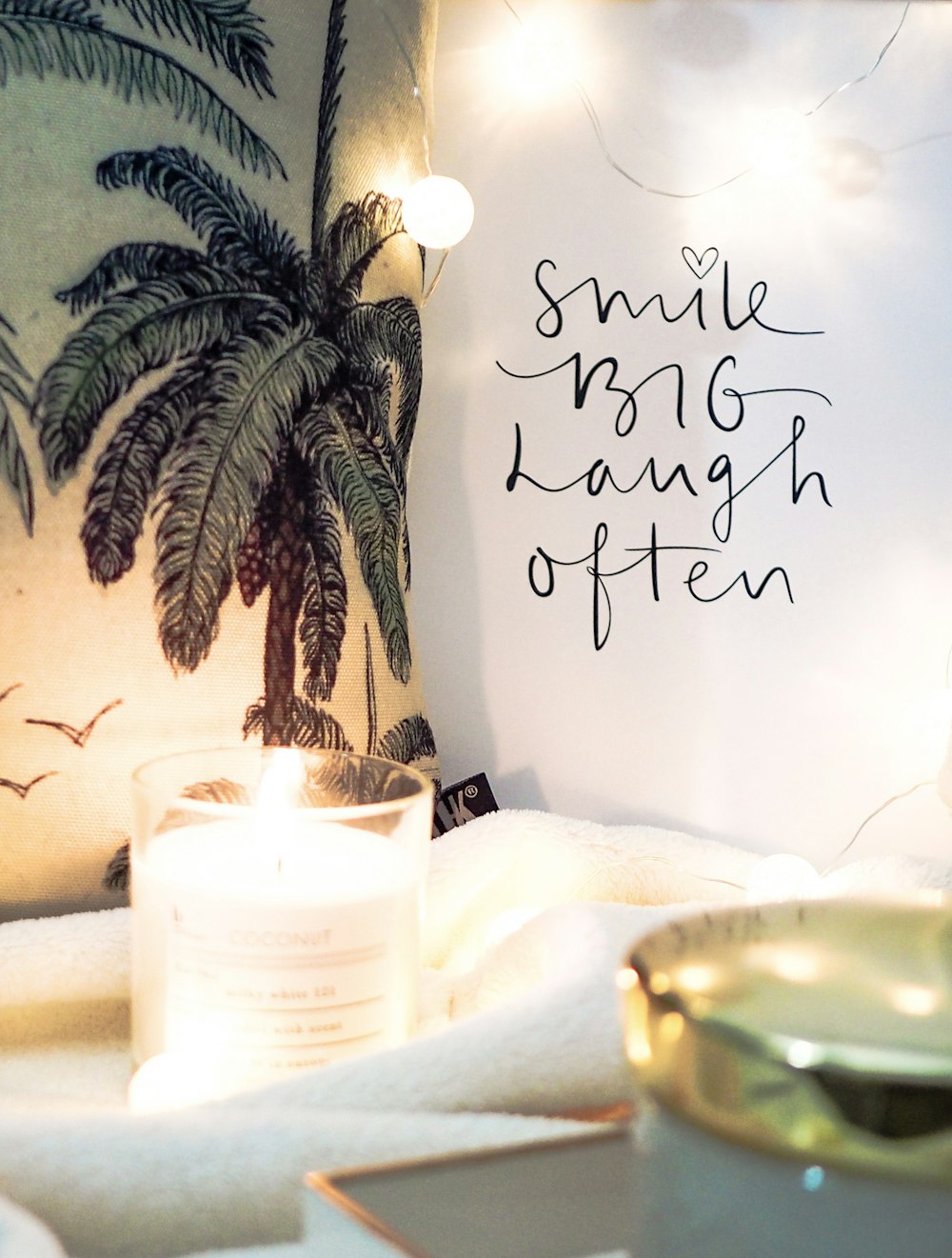 a candle sitting on top of a table next to a sign