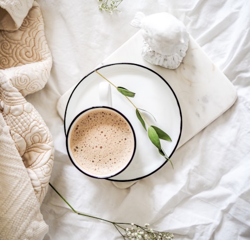 white teacup filled with coffee