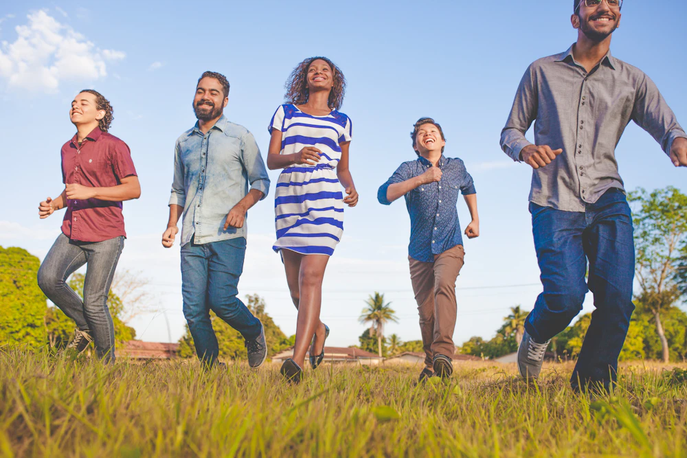 People celebrating outdoors, representing the energy of the PMI Community Empowerment Festival