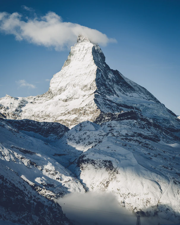 mountain covered by snow under blue sky