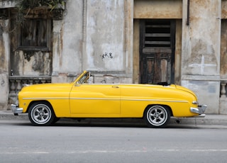 parked vintage classic car near concrete wall