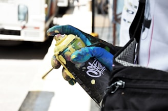 person holding black and yellow spray bottle