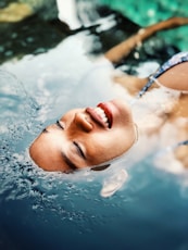 floating woman on body of water