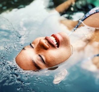 floating woman on body of water