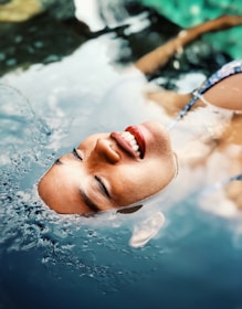 floating woman on body of water
