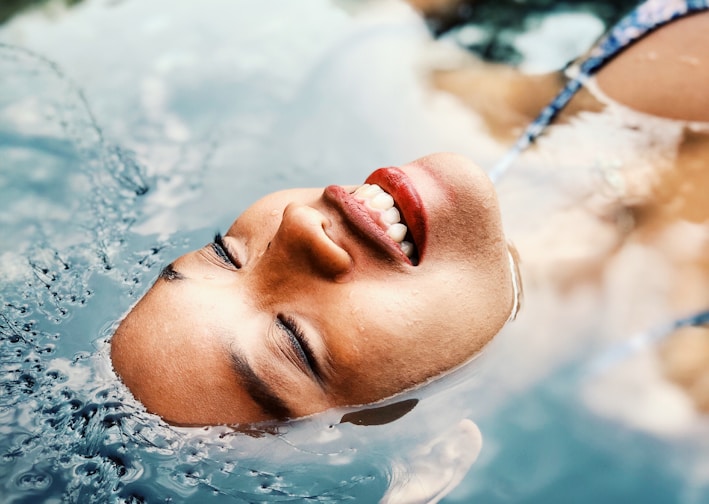 floating woman on body of water