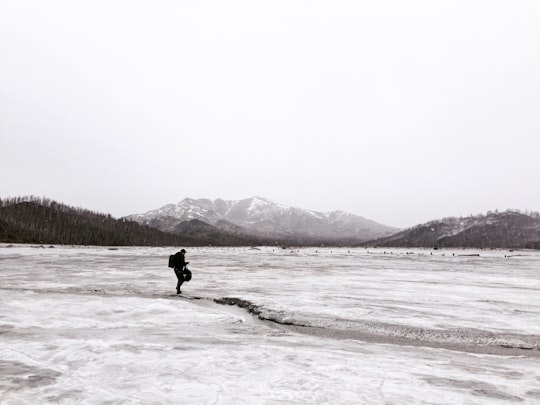 person walking on snow coated groudn in Karabash Russia