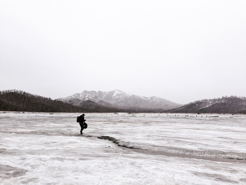 person walking on snow coated groudn