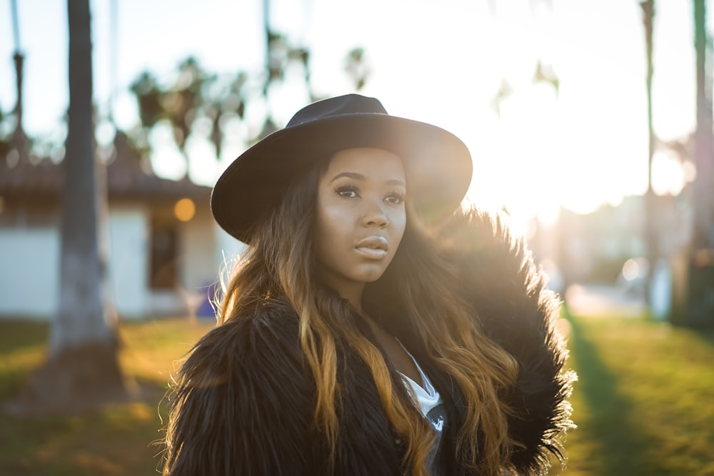 woman wearing black fur coat during daytime