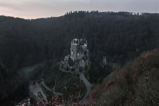 castle surrounded by mountain taken during daytime in Burg Eltz Germany