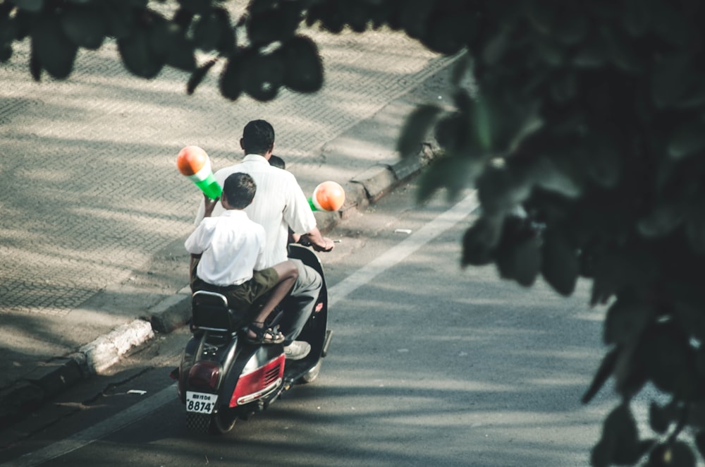 man and boys riding on motorcycle