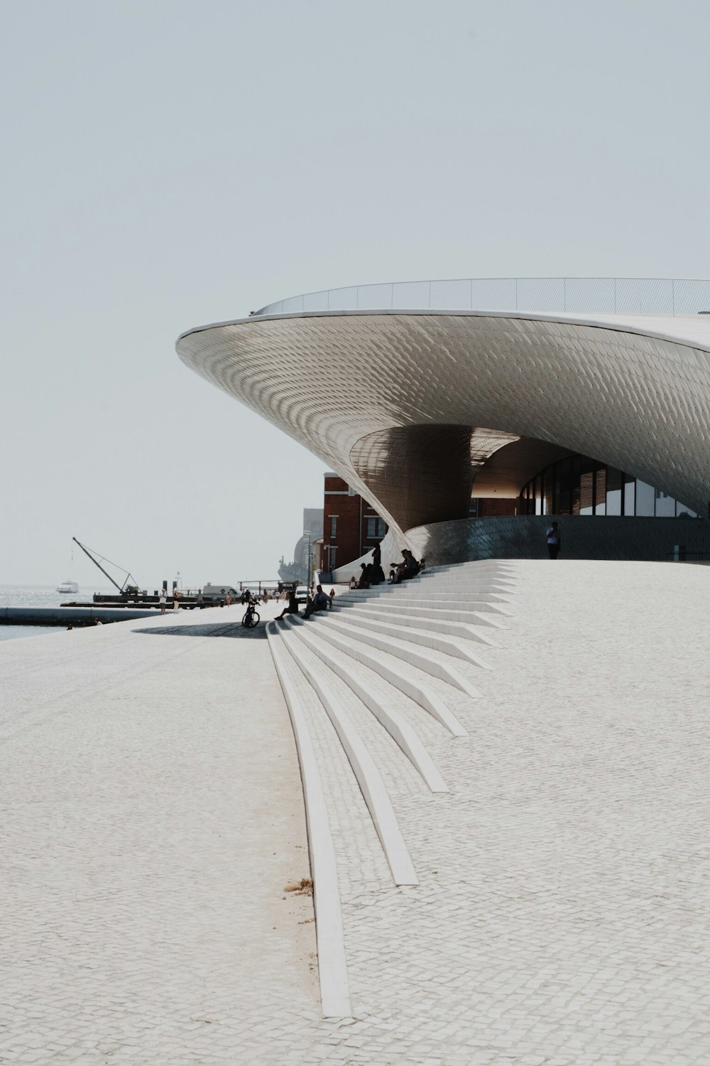 people sitting near gray concrete building