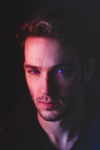 An actor deeply focused during a coaching session in a minimalist studio with soft blue lighting.