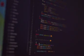 Abstract background of flowing code lines in dark mode with cyan neon highlights.