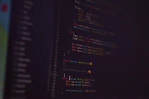 Blurred background with lines of colorful programming code.