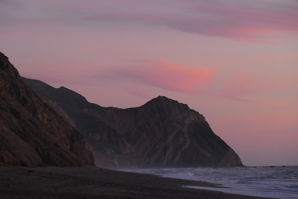 mountain beside body of water