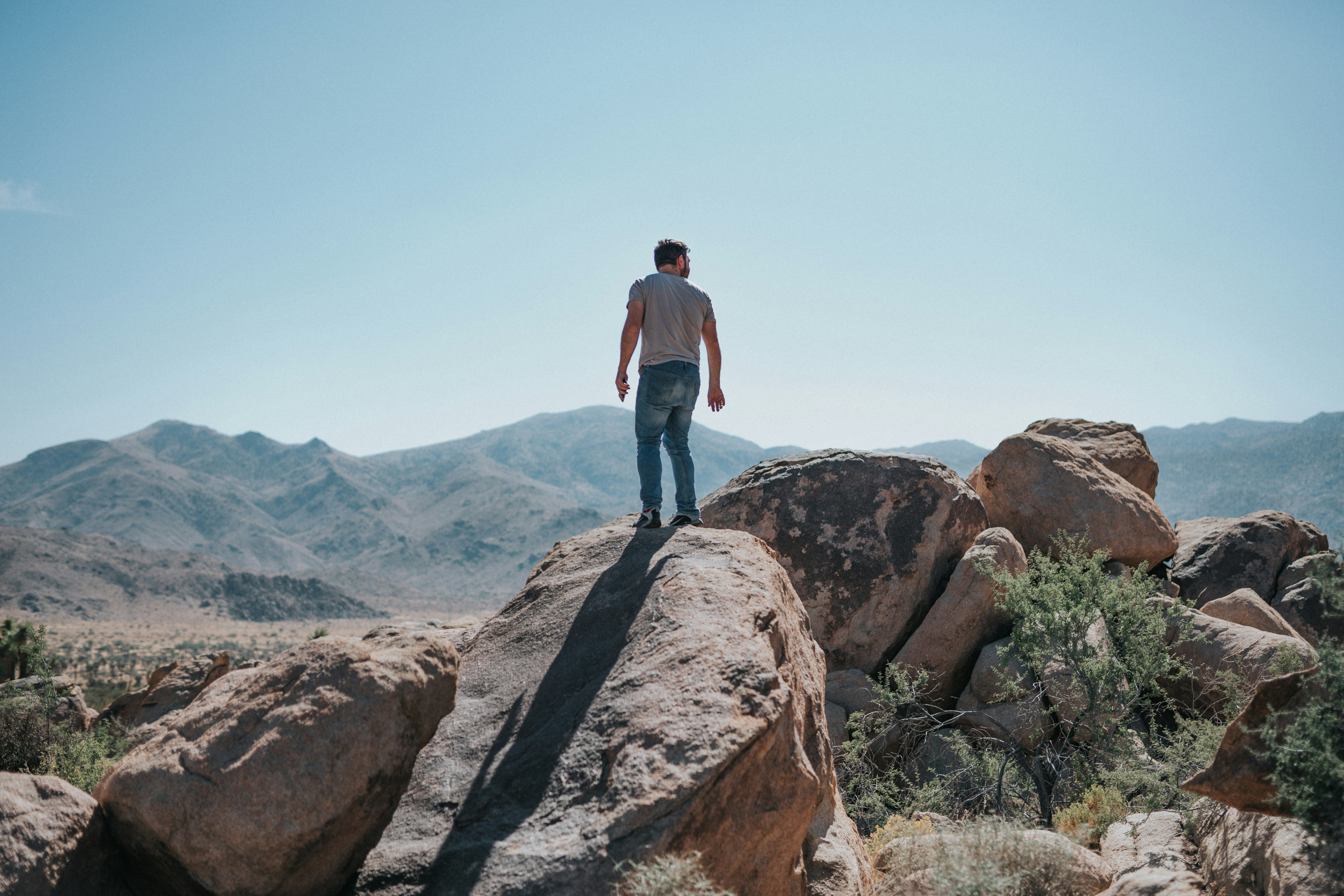 man standing on boulders