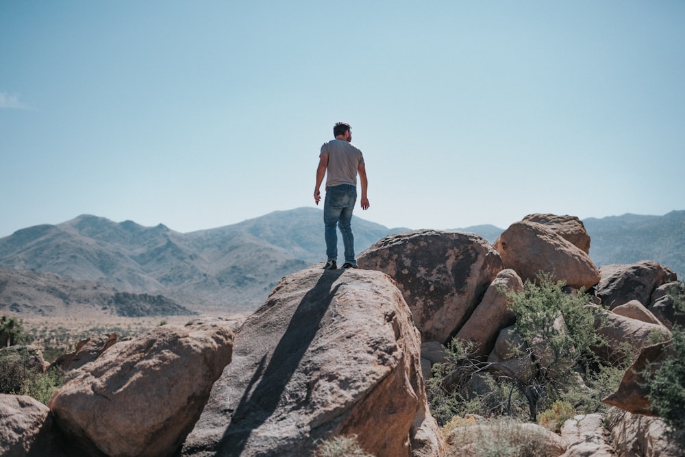 man standing on boulders