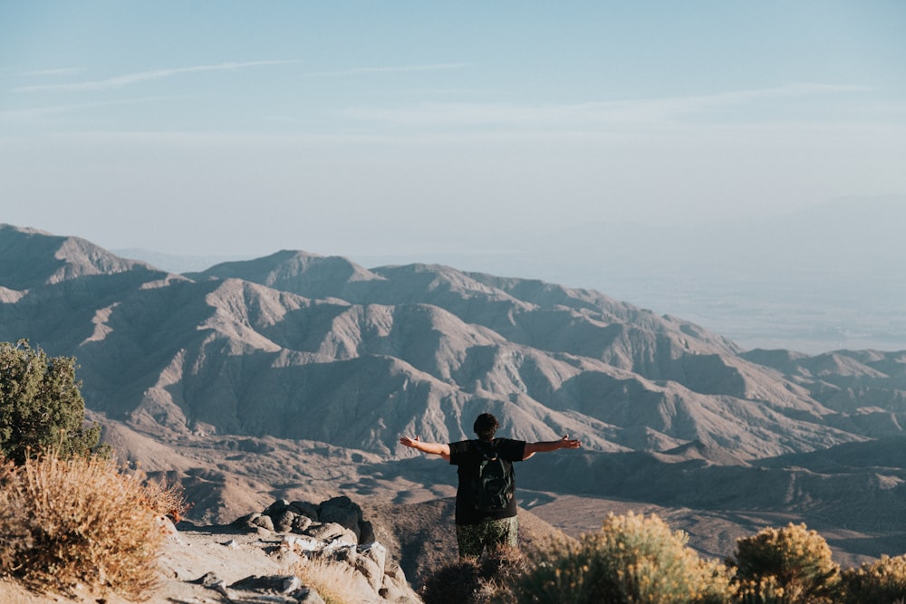 person standing on top of mountain