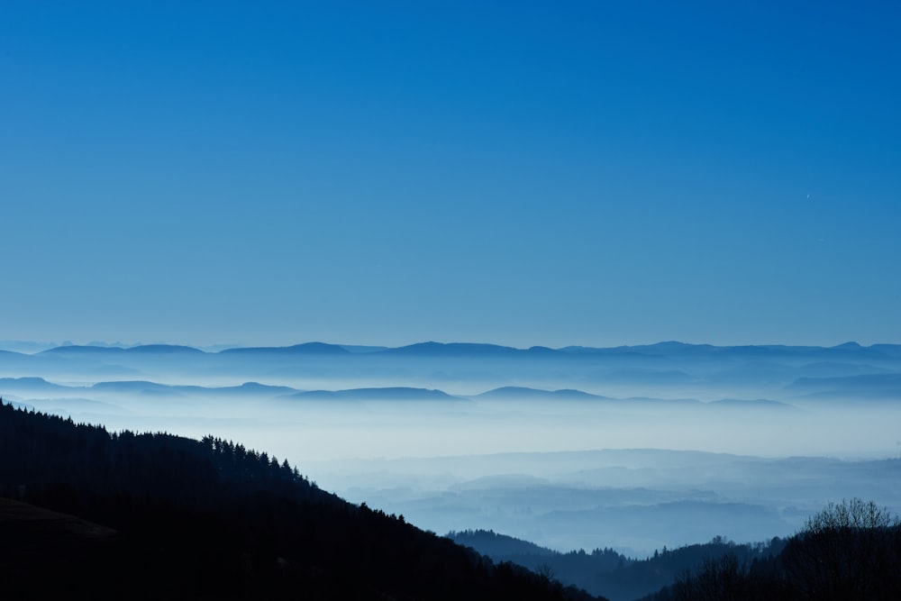 silhouette of mountain under clear blue sky