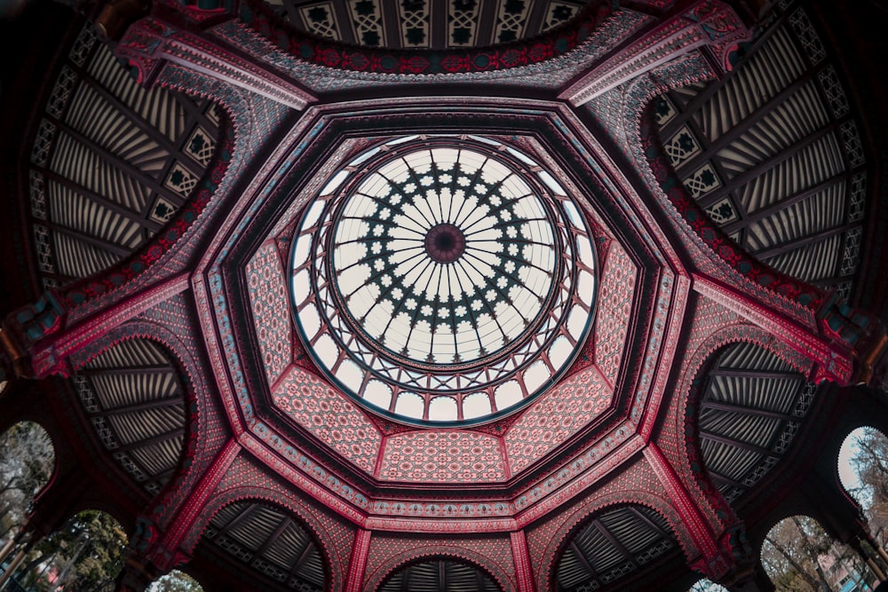 the ceiling of a building with a circular window