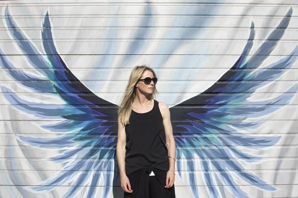 Woman Taking Photo Near Wings Painted Wall Photo Free Human