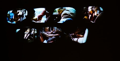 A group of people enjoying a car simulator experience together.