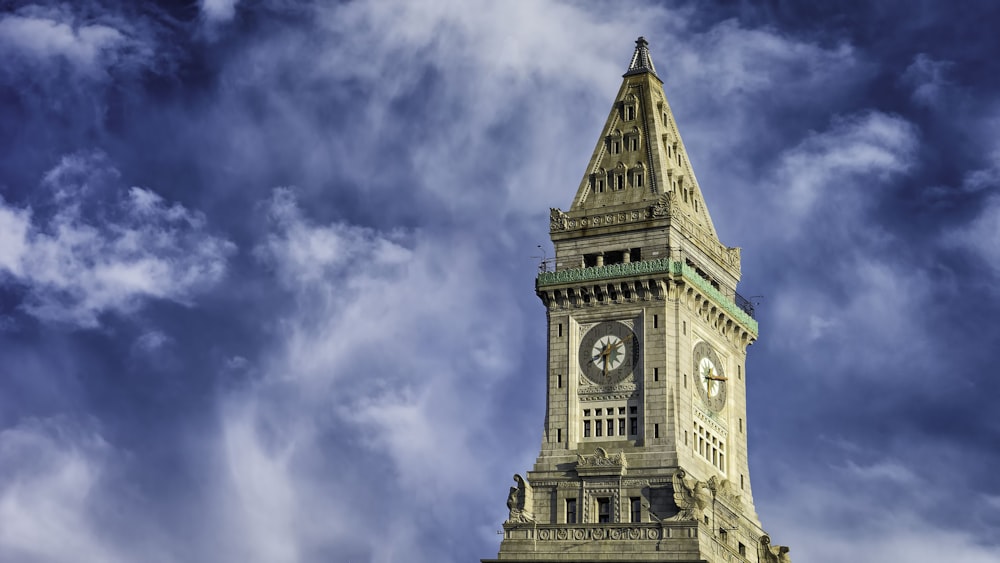 brown clock tower under the cloudy sky