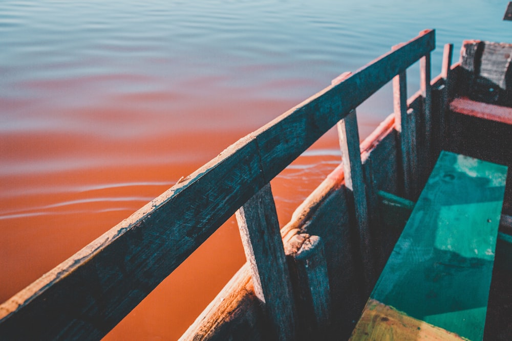 brown boat sailing on body of water during daytime