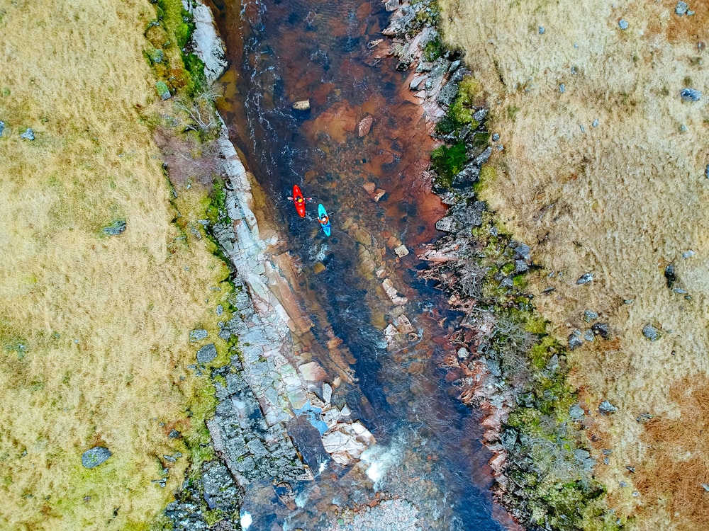 Luftaufnahme von zwei Personen, die tagsüber auf dem Fluss auf dem Kajak fahren