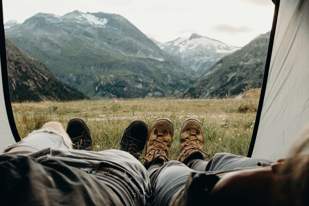 two person lying on tent