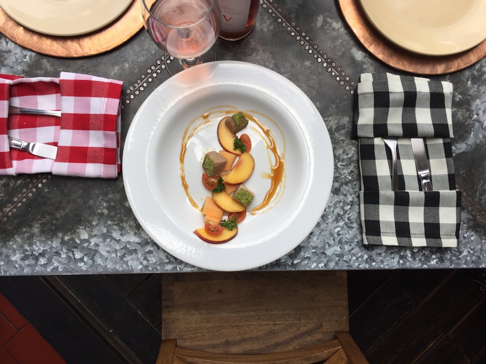 fruit slice on white ceramic plate in the middle of handkerchiefs