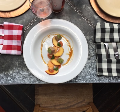 fruit slice on white ceramic plate in the middle of handkerchiefs