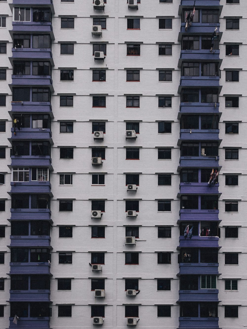 white and purple concrete high-rise building view during daytime