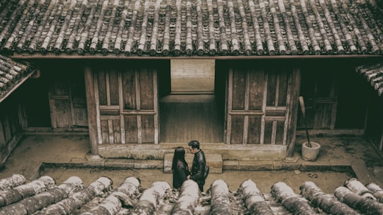 man and woman standing near wooden mouse in Thành phố Hà Giang Vietnam