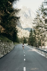 woman standing on asphalt road