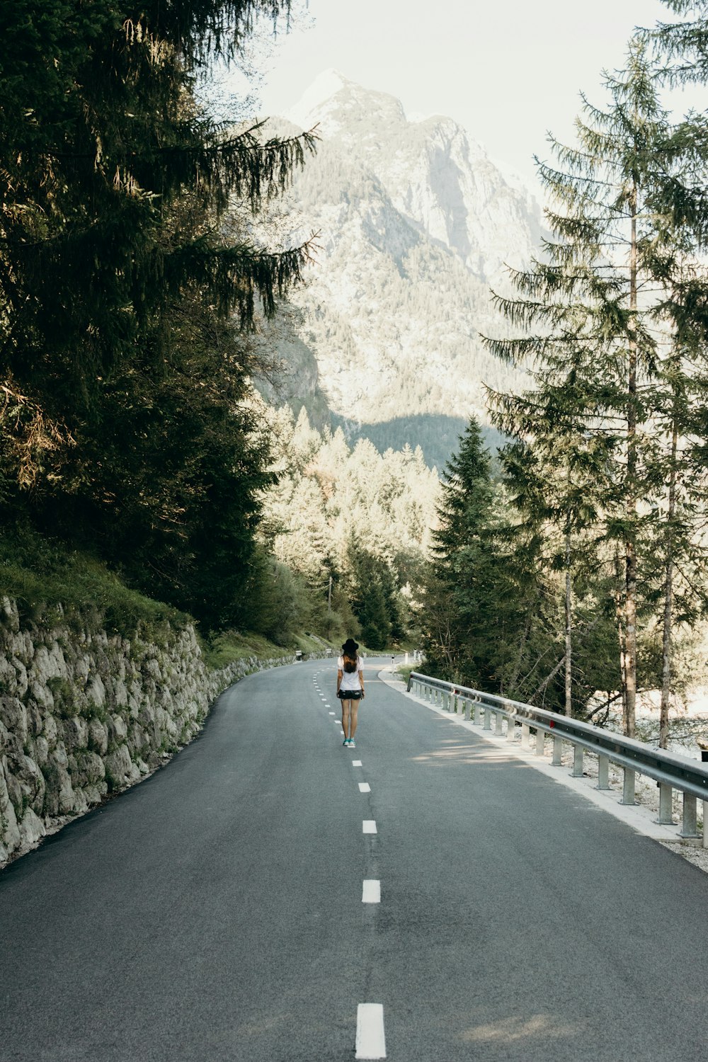 woman standing on asphalt road