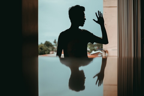 silhouette and reflection of man wearing sunglasses