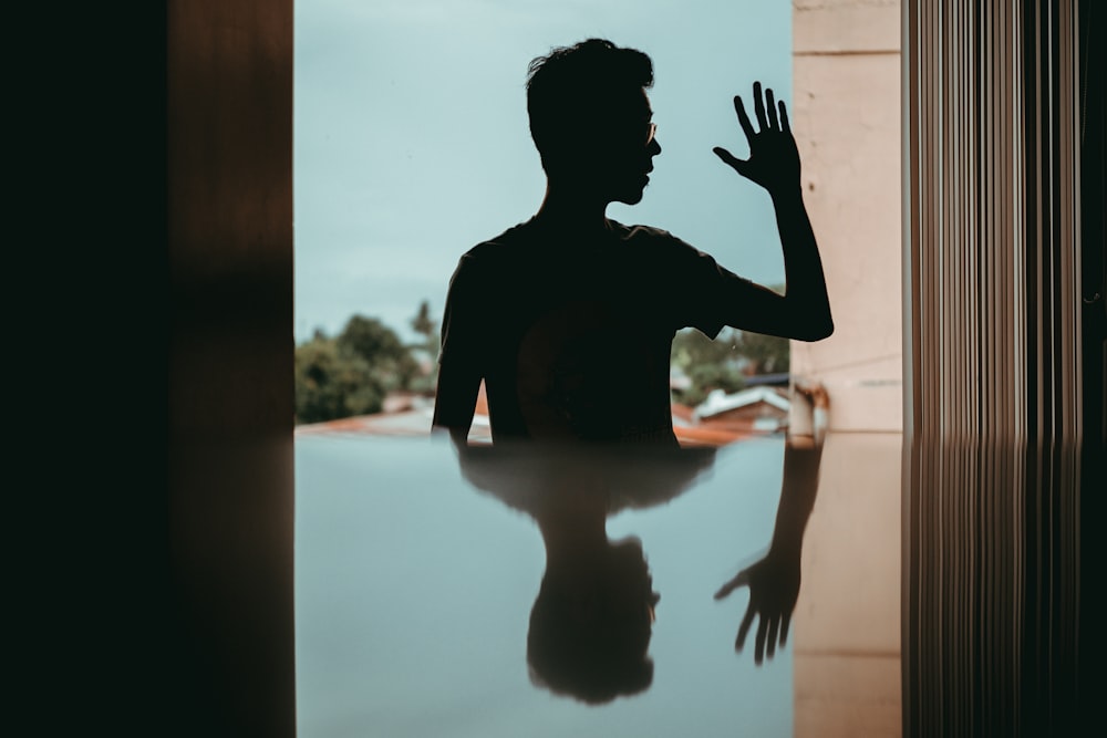 silhouette of man wearing sunglasses