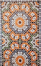 closeup photo of white, orange, and gray area rug
