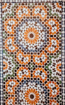 closeup photo of white, orange, and gray area rug