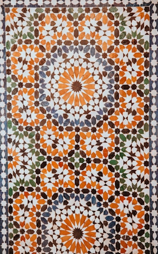 closeup photo of white, orange, and gray area rug