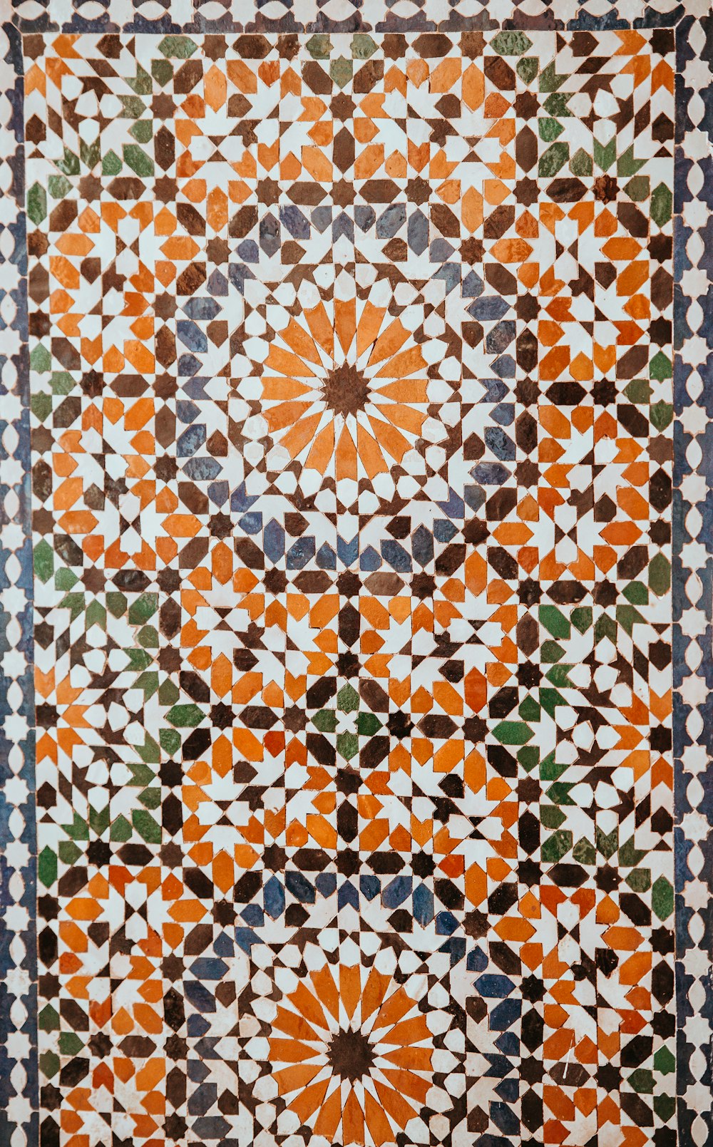 closeup photo of white, orange, and gray area rug