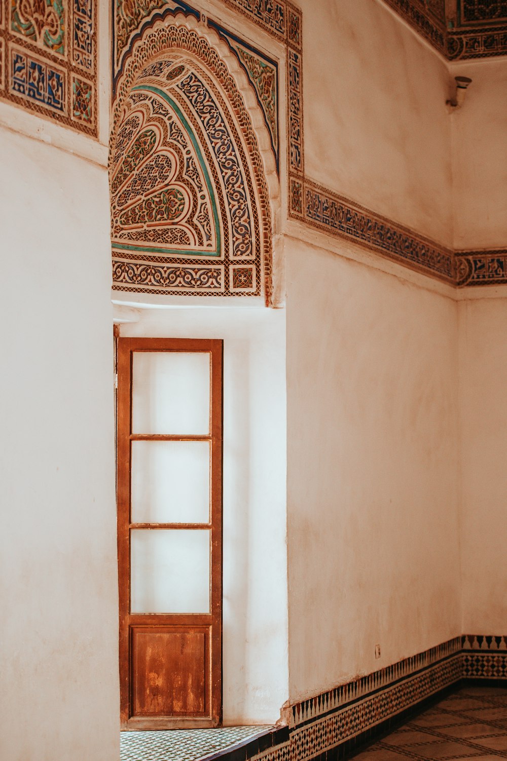 white wooden door beside concrete wall