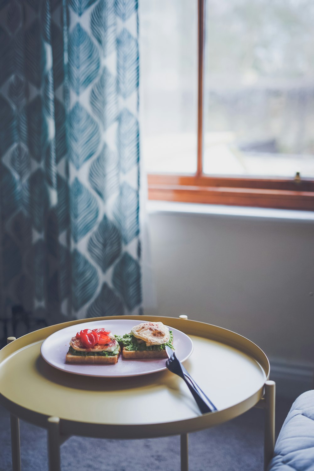 pastries on ceramic plate with cutlery knife and fork inside the room