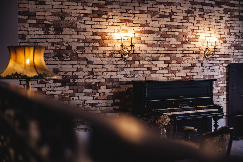 black upright piano near brown lampshade