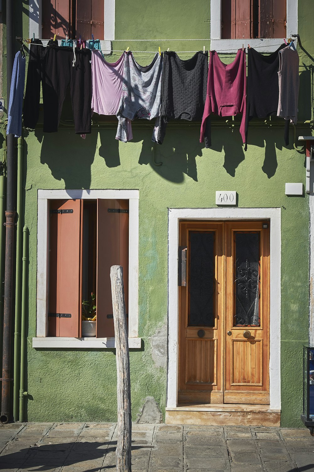 assorted-color clothes hanging on green house