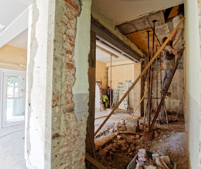 man climbing on ladder inside room