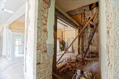 man climbing on ladder inside room